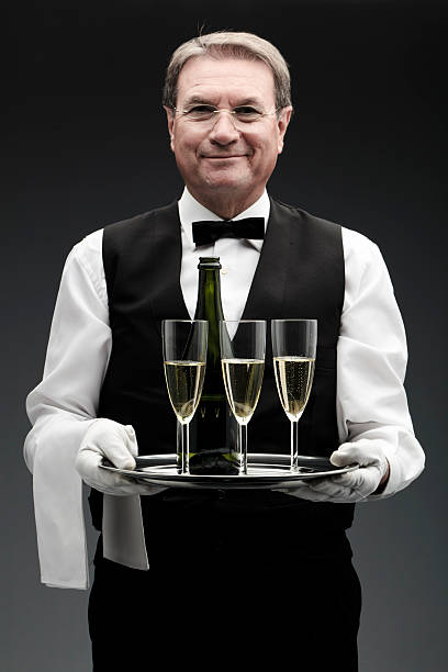 istock butler with three champagne flutes 183844864
