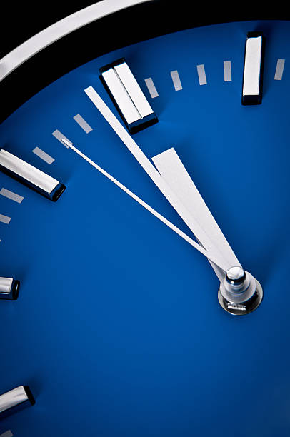 istock Before deadline, close-up of clock face, one minute to 12 183844871