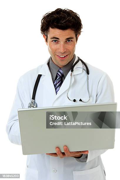 Young Caucasian Doctor With Laptop Looking At Camera Stock Photo - Download Image Now
