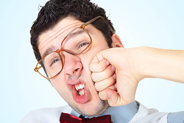 istock Nerdy guy wearing glasses receive a punch in face 183845755
