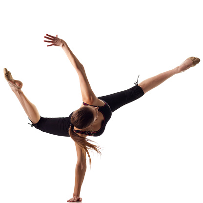 Gymnast girl do headstand on white background