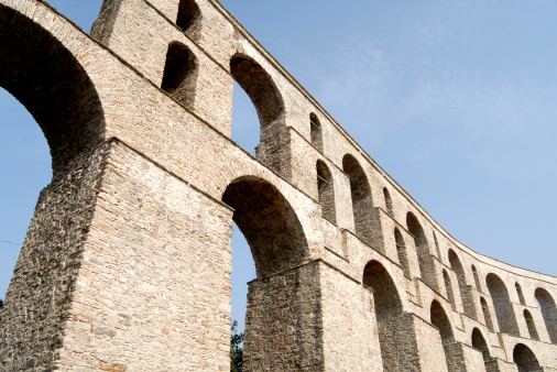 Rome, Italy, June 10, 2023: Sunset on the Coliseum on June 10, 2023 in Roma, Italy. Tourists enjoy the majestic view of the Coliseum of Rome kissed by a warm sunset light