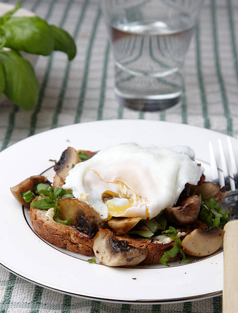 istock Poached egg over herby mushrooms on toast 183847221