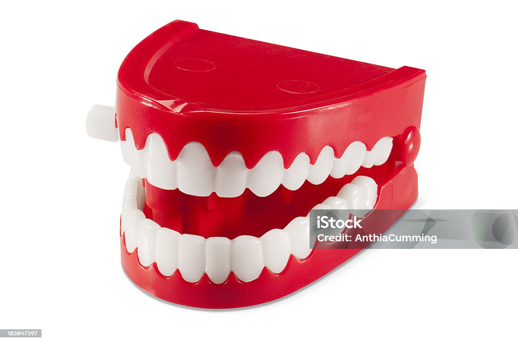Plastic wind-up chattering joke teeth on white background Chattering Joke Teeth on a white background with clipping path Toy Stock Photo
