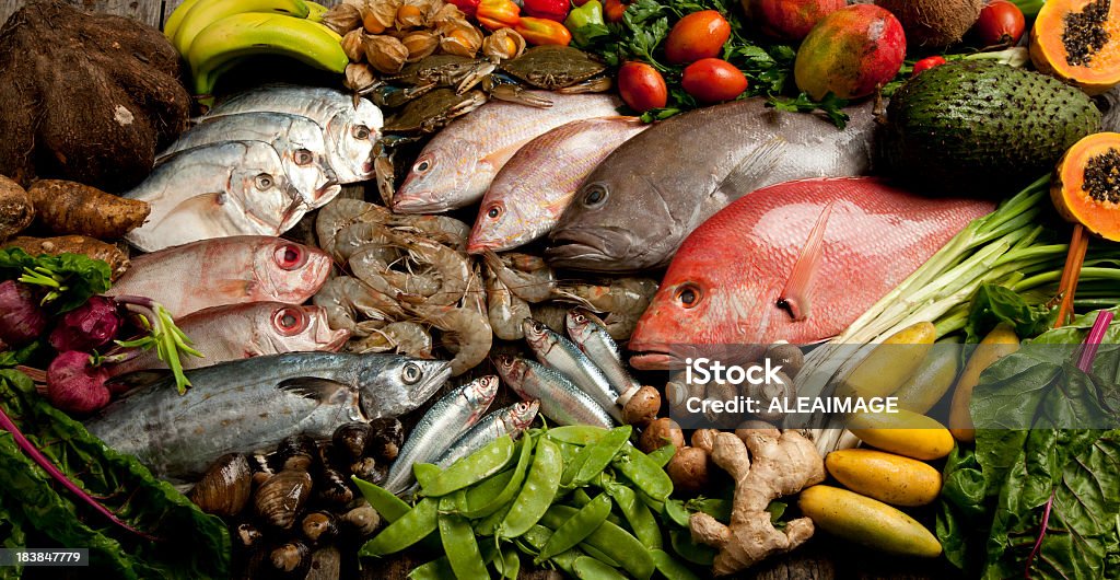 A composition of various seafood, vegetables, and fruits Composition of seafood with vegetables and fruits Banana Stock Photo