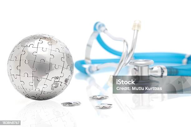 Silver Globe Made Of Puzzle Pieces With Blue Stethoscope Stock Photo - Download Image Now