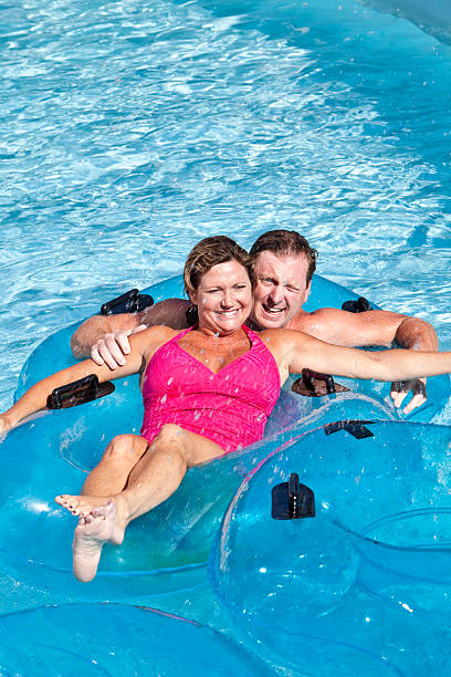 istock Mature couple floating together on innertubes 183848828