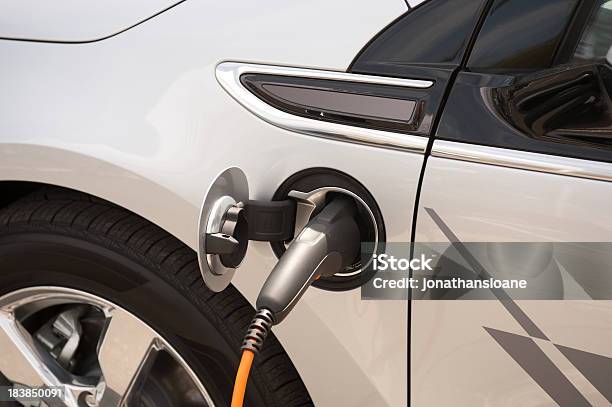 Electric Car Plugged In Stock Photo - Download Image Now - Battery Charger, Electric Car, Alternative Fuel Vehicle