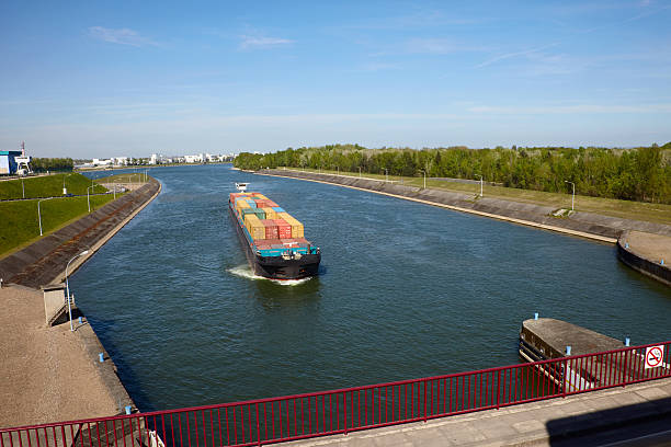 Inland cargo ship "Inland cargo ship approaching the lock at the Rhine at Marckolsheim, France" sluice photos stock pictures, royalty-free photos & images