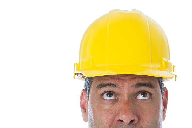 istock Part of man wearing hard hat looking up construction worker 183850732