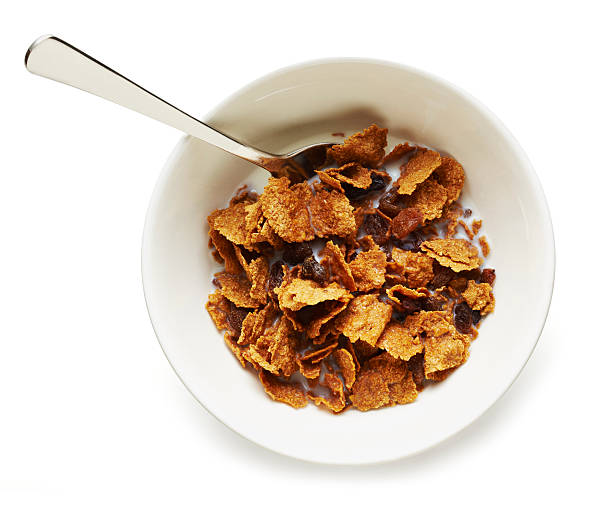 Breakfast "Bowl of sultana and bran flakes breakfast cereal, in a white bowl, from above. Clipping path included and on pure white background with soft drop shadow." bran stock pictures, royalty-free photos & images