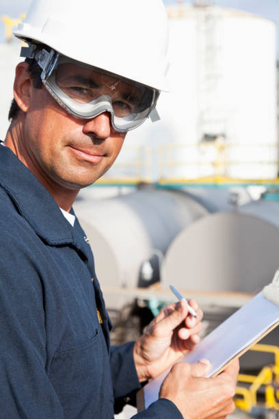 istock Male worker at industrial plant writing on clipboard 183851692
