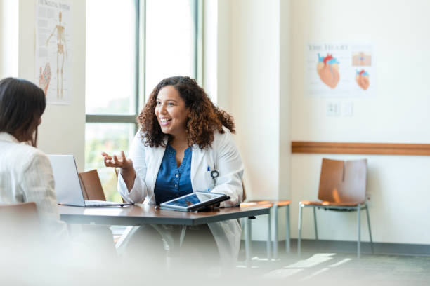 istock Female physician gestures while meeting with the unrecognizable female patient 1838520709