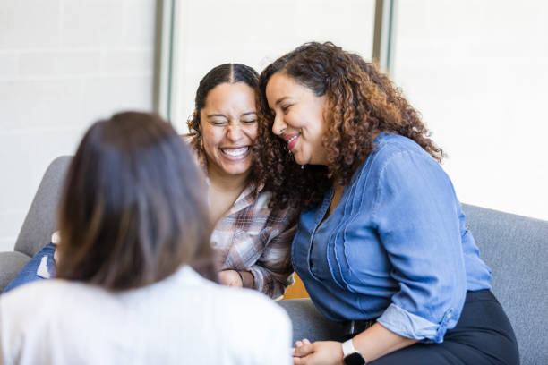 istock Two female friends smile and embrace one another in support 1838520712