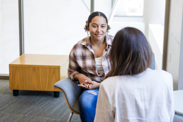 Young adult female student meets with her college counselor