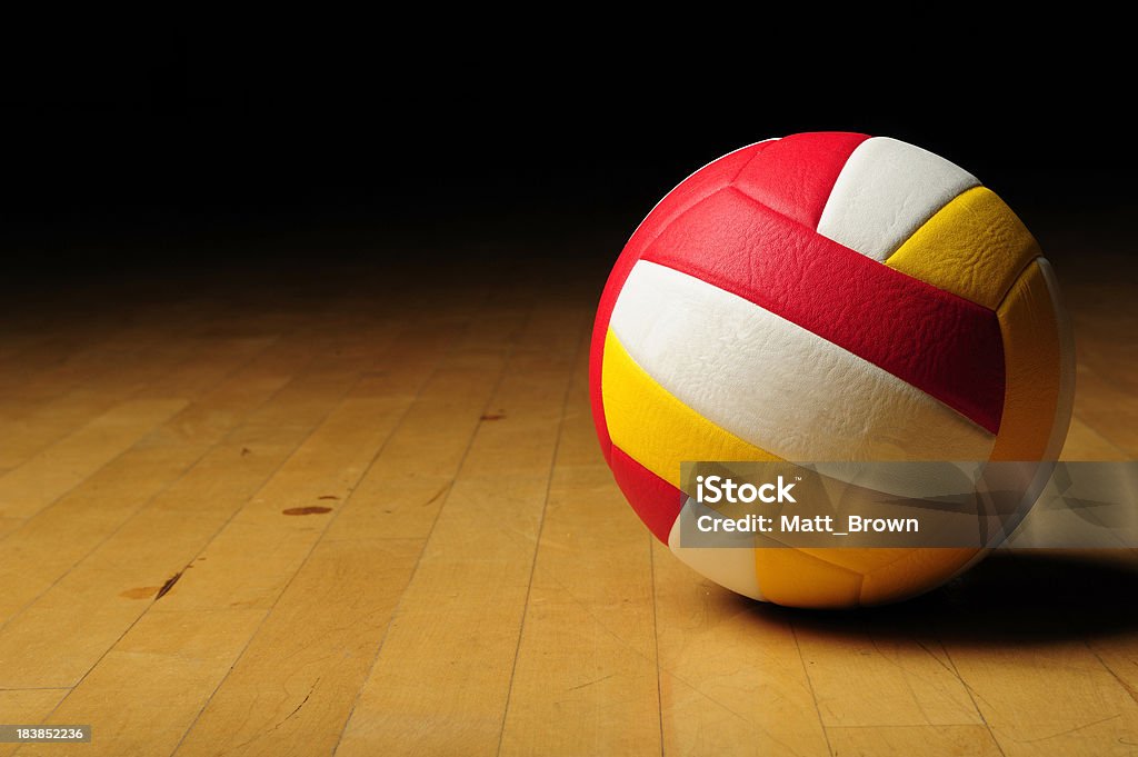 Volleyball in an empty gym Volleyball on Wood Floor Competition Stock Photo