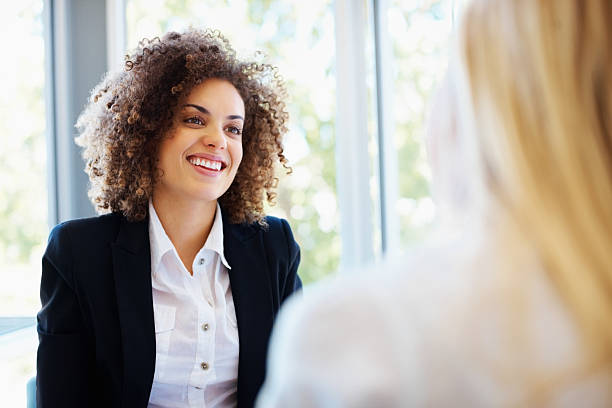 istock Mixed race female executive discussing with coworker 183852251