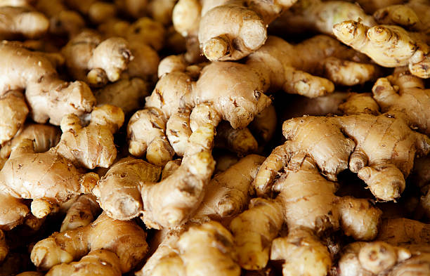 Fresh Ginger "Abundance of fresh ginger on sale in the Central Market of Sandakan, Malaysia." ginger spice stock pictures, royalty-free photos & images