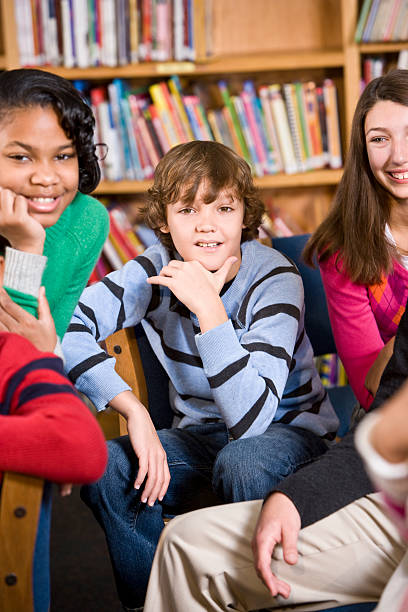 istock Boy with friends in school library 183852477