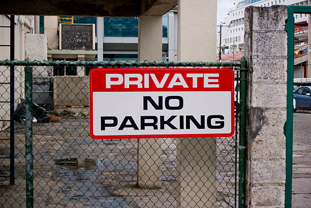 istock no parking sign on fence 183852638