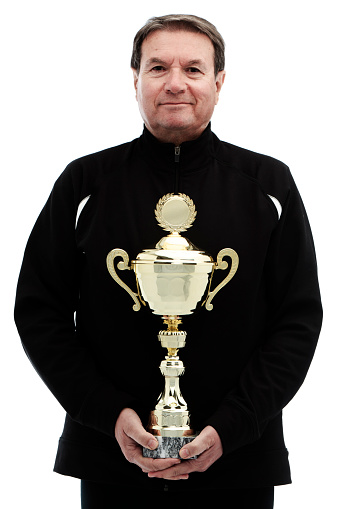 senior man with golden cup