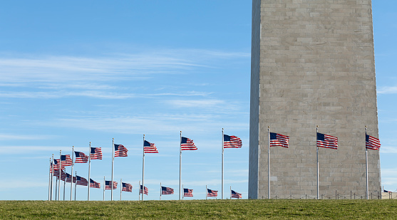 Flags catching the breeze circling the base of the Washington Monument.