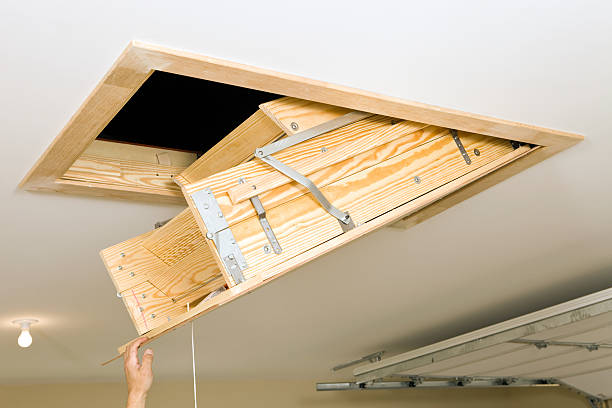Folding Attic Access Ladder in a Garage  attic photos stock pictures, royalty-free photos & images