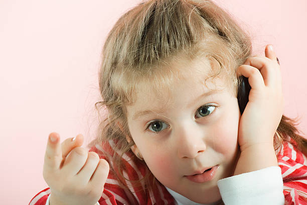 istock Little girl with mobile phone 183853337