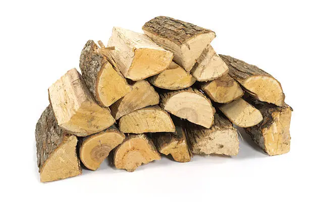 Firewood, split, stacked, and isolated on white.