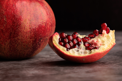 Fresh whole and half of pomegranate isolated on white background from top view