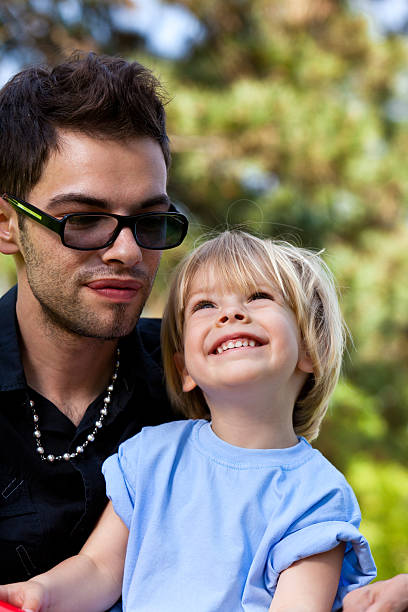 istock Young Father And Son Relaxing Outdoors 183853884