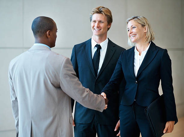 istock Happy, female executive shaking hands with her colleague 183854408