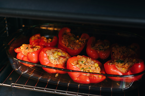 Vegetarian stuffed peppers roasting  in the oven