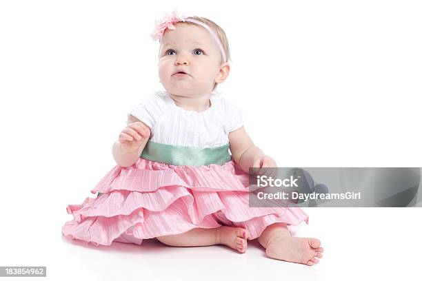 Baby Girl Wearing Dress And Sitting On White Background Stock Photo - Download Image Now