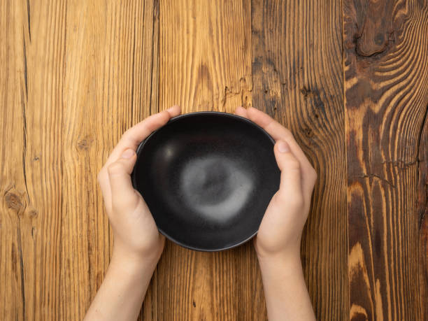 istock Bowl in Hands, Empty Bowl in Arms on Wooden Background, Vintage Kitchen Tableware Mockup 1838553823