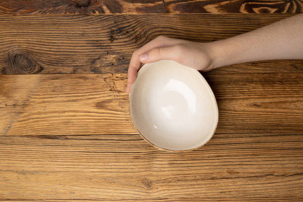 istock Bowl in Hands, Empty Bowl in Arms on Wooden Background, Vintage Kitchen Tableware Mockup 1838553824