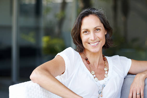 istock Charming, mature woman relaxing on a sofa at home 183855851