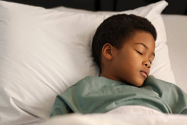 istock little boy sleeping in the hospital 183856105