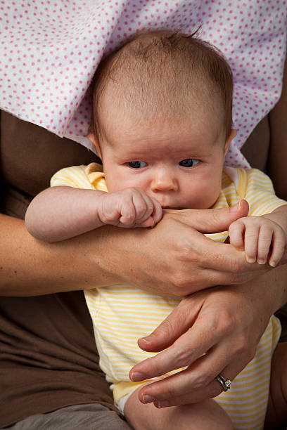 Baby Girl Looking Over Mom's Hand