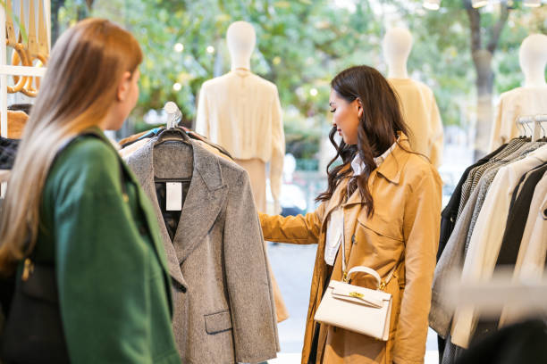 istock Two young women shopping in clothes store 1838570102
