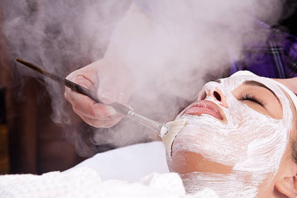 Lady having a facial spa treatment stock photo