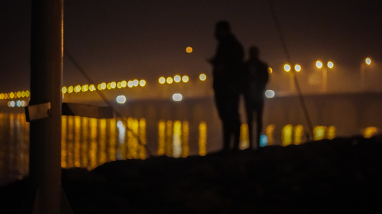 Pretty aspect of blurry guys who’s fishing in Shaikh Jaber bridge in Kuwait