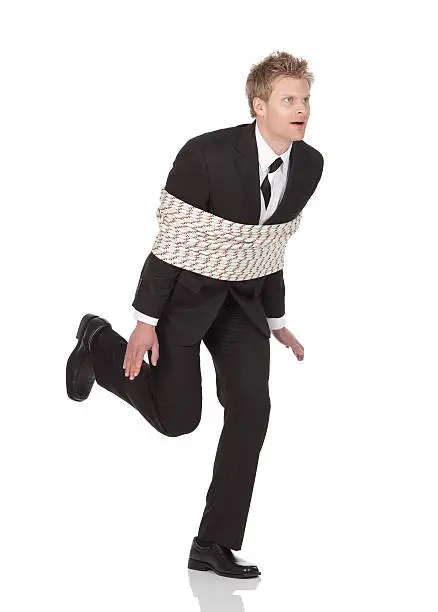 Businessman tied with rope and runninghttp://www.twodozendesign.info/i/1.png