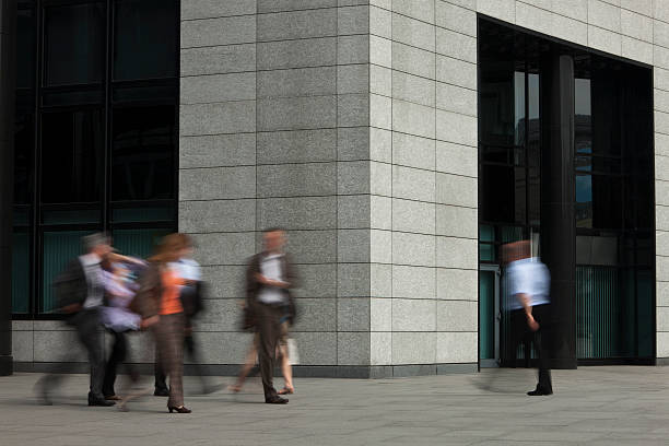 istock Blurred Businessmen Walking Outside Office Building 183857914