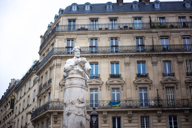 Paris, France: The elegant Place St George in the 9th arrondissement; the statue was put into place in 1911 and depicts designer Paul Gavarni.