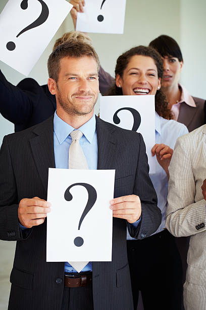 istock Business man holding question mark sign 183858502