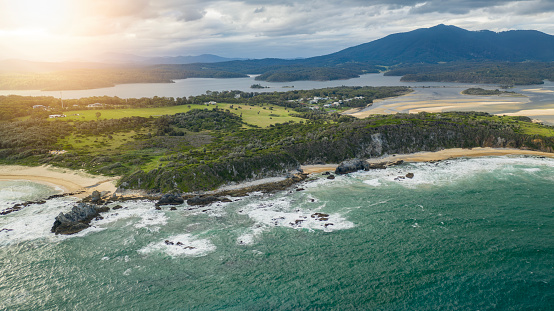 Coastal landscape scene with a lake and mountains in southern New South Wales.