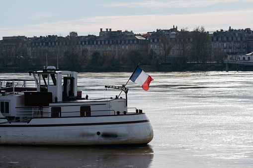 Boat with french flag with in Bordeaux in France.
