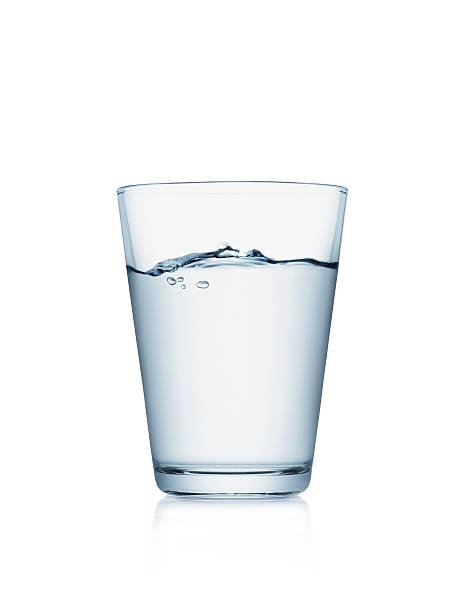 Glass of water isolated on white Glass of water isolated on white background with wave surface level tumbler glass stock pictures, royalty-free photos & images
