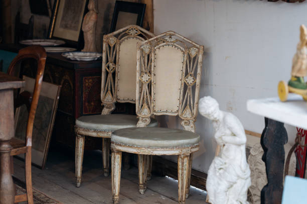 istock Vintage chairs and statue at flea market. 1838588774